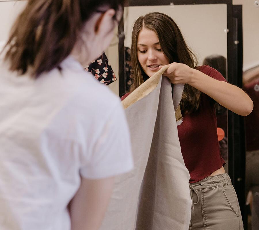 students from the degree in theatre arts making a costume with fabric