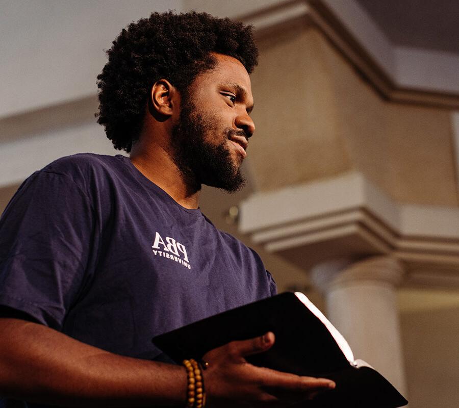 PBA student holds a bible in chapel.